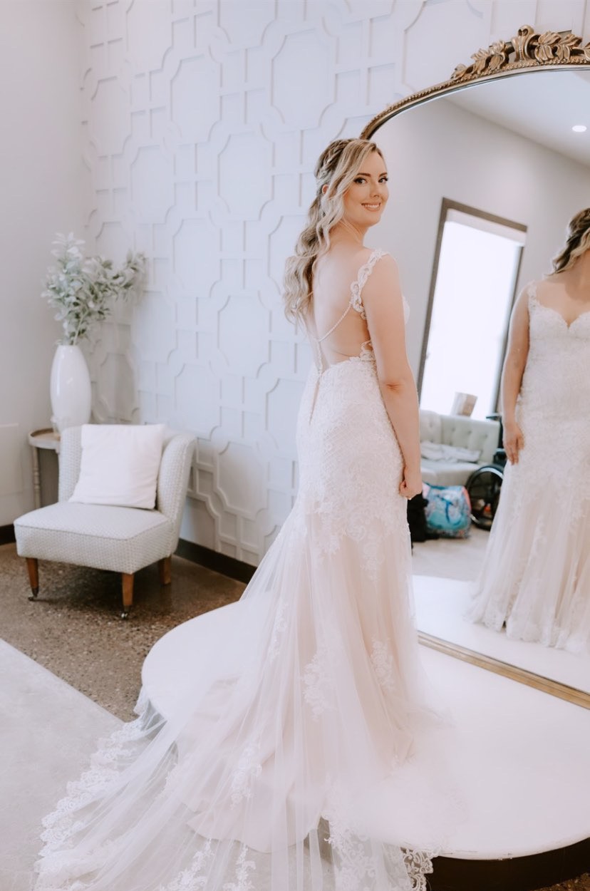 Bride holding bouquet with soft updo and veil