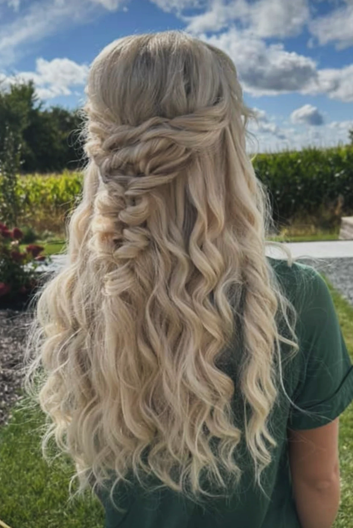 Long blonde bridal hairstyle with loose curls and braided detail